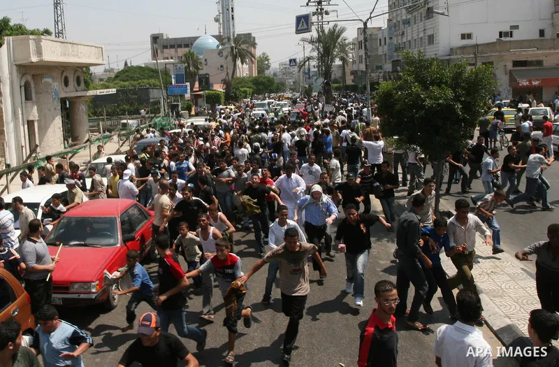 Fatah movement supporters shout as they take part in a rally following Friday noon prayers in Gaza City. Security forces from the ruling Hamas detained four journalists, including an AFP photographer as it broke up a mas...