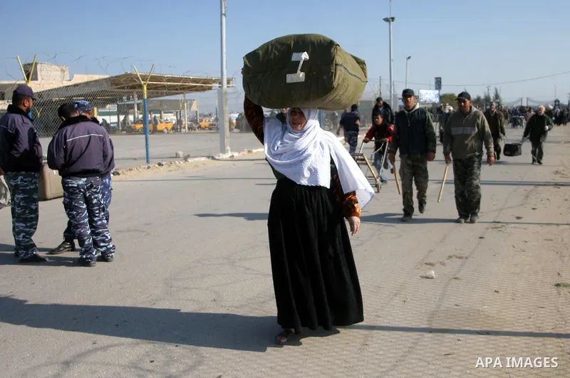 Palestinians wait to cross the Rafah border crossing from the Gaza Strip into Egypt. Citing security threats, Israel allows the Rafah crossing, Gaza's only gateway to the outside world, to operate only sporadically, lead...