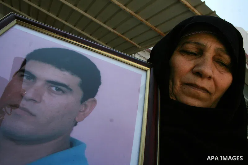 Palestinian women hold pictures of relatives they say are being held in Israeli jails during a protest demanding the release of prisoners in Gaza City. After a nearly 10-month standoff in efforts to secure the release of...