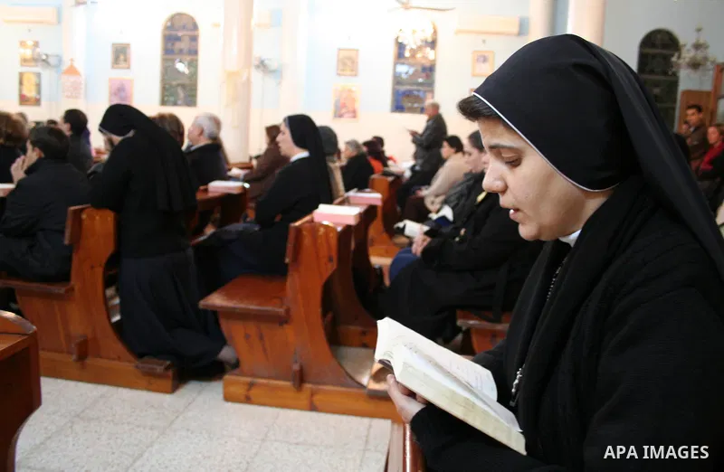 Christian worshippers pray in Deir al-Laten Church ahead of Christmas in Gaza.