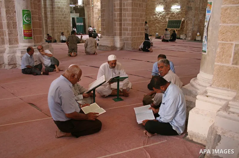 A Palestinian elderly men reads the Koran in Al-Omari mosque in Gaza City, on the third day of the holy month of Ramadan. Most of the world's 1.2 billion Muslims began Ramadan today, a holy month of dawn-to-dusk fasting,...