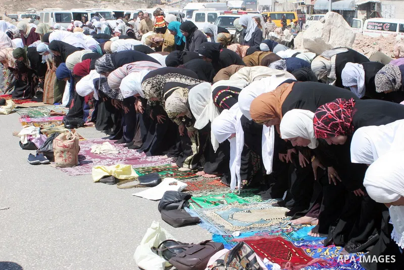 Palestinian worshippers wait hoping to cross the Israeli manned Qalandiya checkpoint and controversial separation barrier, to go to Jerusalem to take part in prayers at the al-Aqsa mosque, the third most holy site for Mu...
