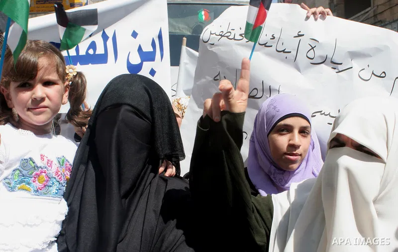 Palestinian women protesters gather with banners calling for the release of imprisoned family members linked to the Islamist Hamas movement and an end to political arrests outside Al-Bireh mosque in the West Bank city of...