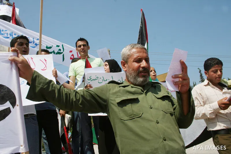 Palestinians carry Palestinian flags during a rally calling for unity between the Gaza Strip and the West bank, in Gaza City. The Israeli Cabinet voted overwhelmingly on Sunday to release 90 Palestinian prisoners in an e...