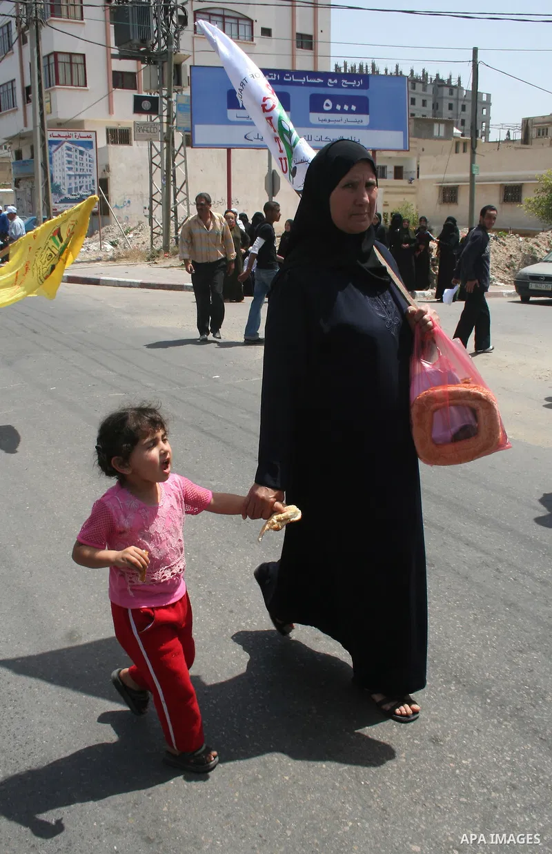 A palestinian woman holds flag during a demonstration for Palestinian workers against the siege in Gaza city. Palestinians have chosen to demonstrate in the run up to Labour Day against the closure of checkpoints between...
