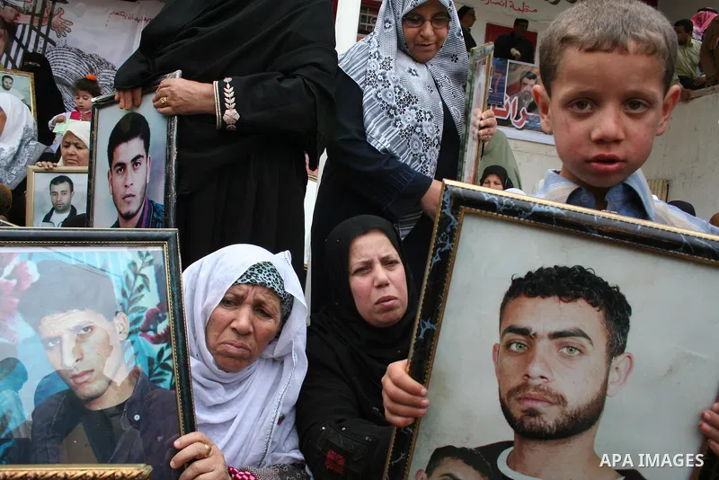 Palestinians hold pictures of their relatives during a protest calling for the release of Palestinian prisoners from Israeli jails, in front of the red cross headquarters in Gaza.