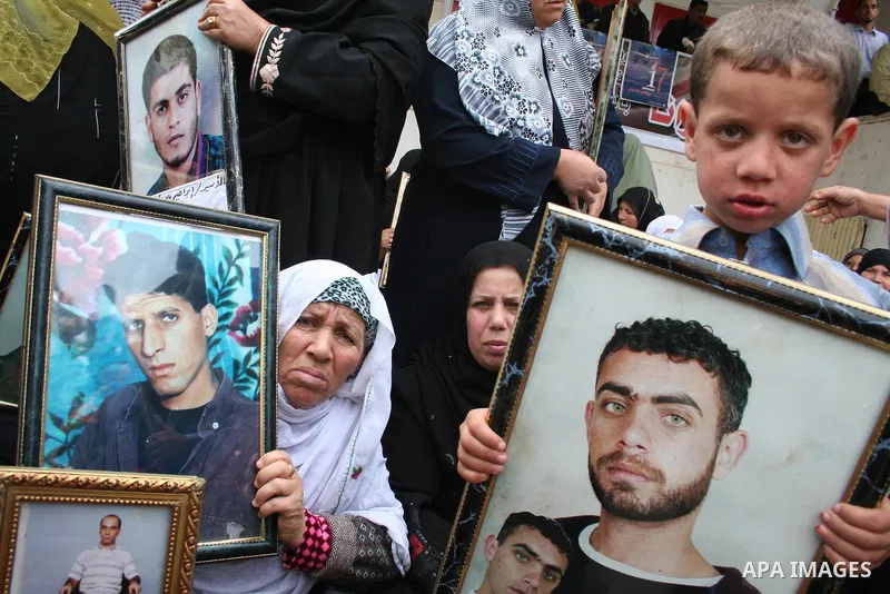 Palestinians hold pictures of their relatives during a protest calling for the release of Palestinian prisoners from Israeli jails, in front of the red cross headquarters in Gaza.