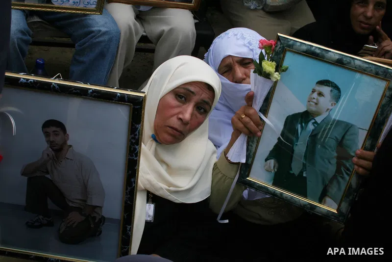 Palestinians hold pictures of their relatives during a protest calling for the release of Palestinian prisoners from Israeli jails, in front of the red cross headquarters in Gaza.