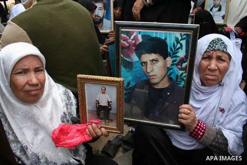 Palestinians hold pictures of their relatives during a protest calling for the release of Palestinian prisoners from Israeli jails, in front of the red cross headquarters in Gaza.