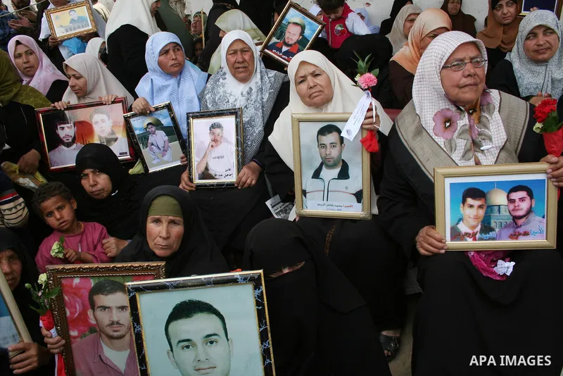 Palestinians hold pictures of their relatives during a protest calling for the release of Palestinian prisoners from Israeli jails, in front of the red cross headquarters in Gaza.