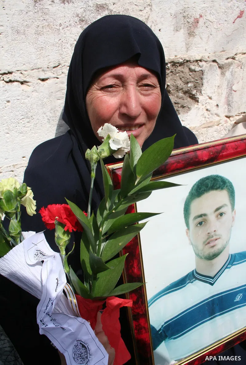 A Palestinian woman hold pictures of her relatives during a protest calling for the release of Palestinian prisoners from Israeli jails, in front of the red cross headquarters in Gaza.