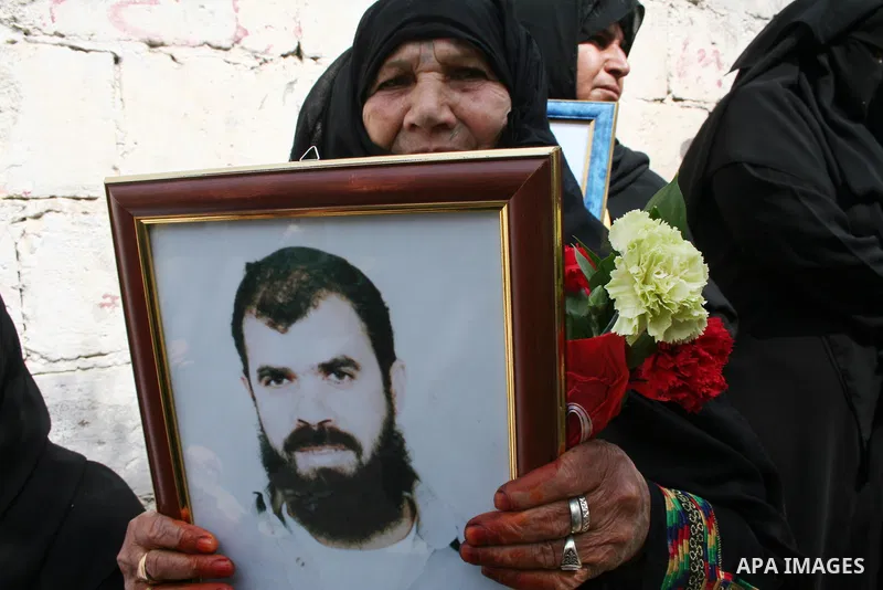 A Palestinian woman hold pictures of their relatives during a protest calling for the release of Palestinian prisoners from Israeli jails, in front of the red cross headquarters in Gaza.