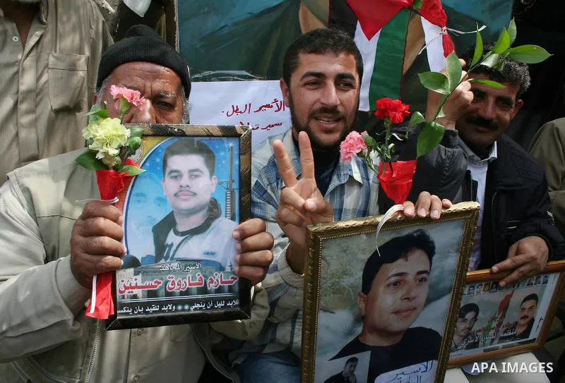 Palestinians hold pictures of their relatives during a protest calling for the release of Palestinian prisoners from Israeli jails, in front of the red cross headquarters in Gaza.