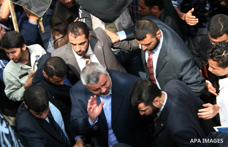 Palestinian Prime Minister Ismail Haniyeh waves to the relatives of prisoners during a protest calling for the release of Palestinian prisoners from Israeli jails, in Gaza.
