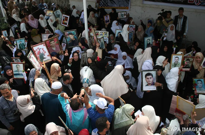 Palestinians hold pictures of their relatives during a protest calling for the release of Palestinian prisoners from Israeli jails, in front of the red cross headquarters in Gaza.