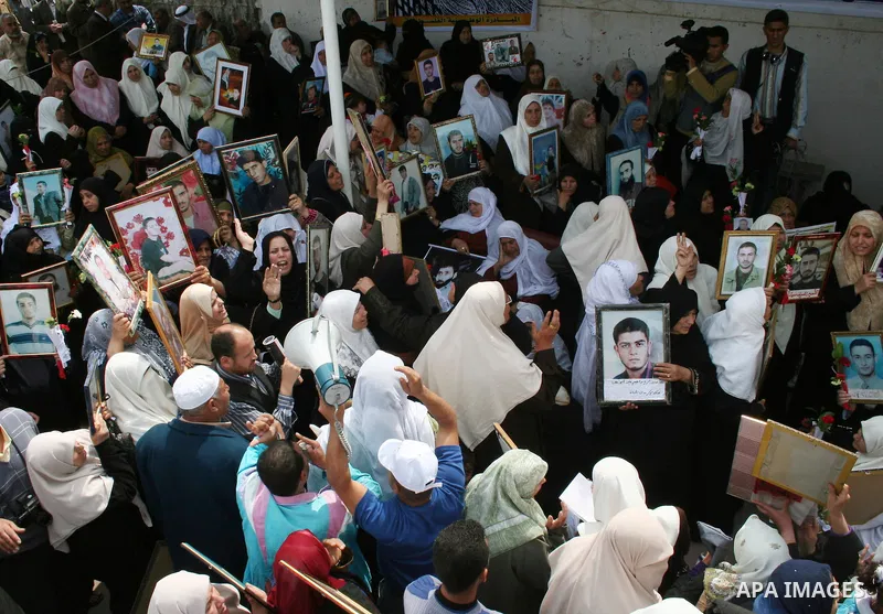 Palestinians hold pictures of their relatives during a protest calling for the release of Palestinian prisoners from Israeli jails, in front of the red cross headquarters in Gaza.