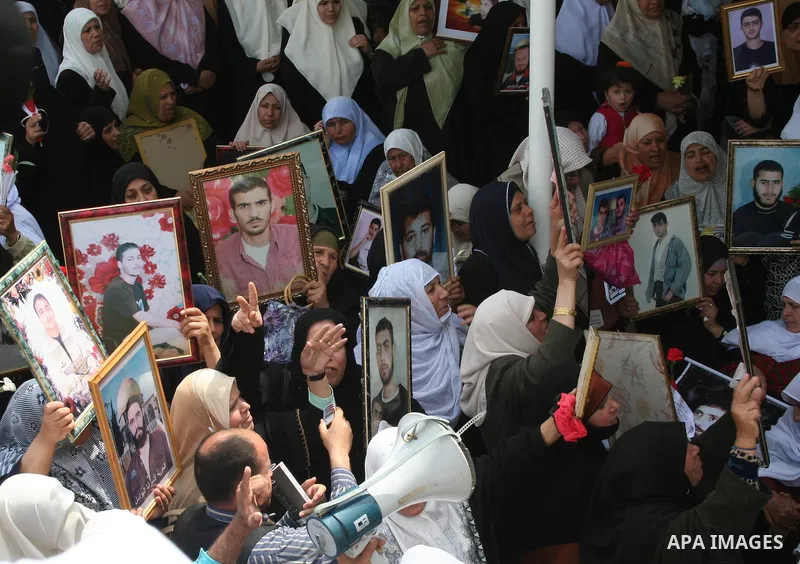Palestinians hold pictures of their relatives during a protest calling for the release of Palestinian prisoners from Israeli jails, in front of the red cross headquarters in Gaza.