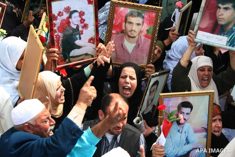 Palestinians hold pictures of their relatives during a protest calling for the release of Palestinian prisoners from Israeli jails,in front of the red cross headquarters in Gaza...