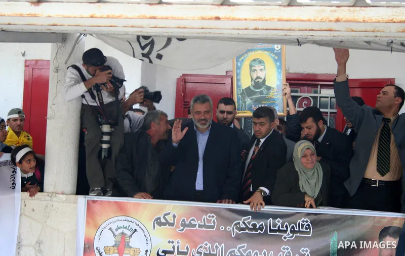 Palestinian Prime Minister Ismail Haniyeh waves to the relatives of prisoners during a protest calling for the release of Palestinian prisoners from Israeli jails,in front of the red cross headquarters in Gaza.