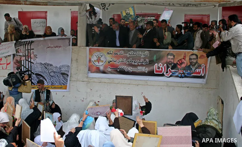 Palestinian Prime Minister Ismail Haniyeh waves to the relatives of prisoners during a protest calling for the release of Palestinian prisoners from Israeli jails,in front of the red cross headquarters in Gaza...