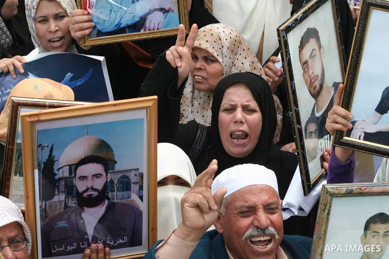 Palestinians hold pictures for their relatives during a protest calling for the release of Palestinian prisoners from Israeli jails in front of the red cross headquarters in Gaza.