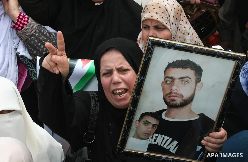 Palestinian women hold pictures for their relatives during a protest calling for the release of Palestinian prisoners from Israeli jails in front of the red cross headquarters in Gaza.