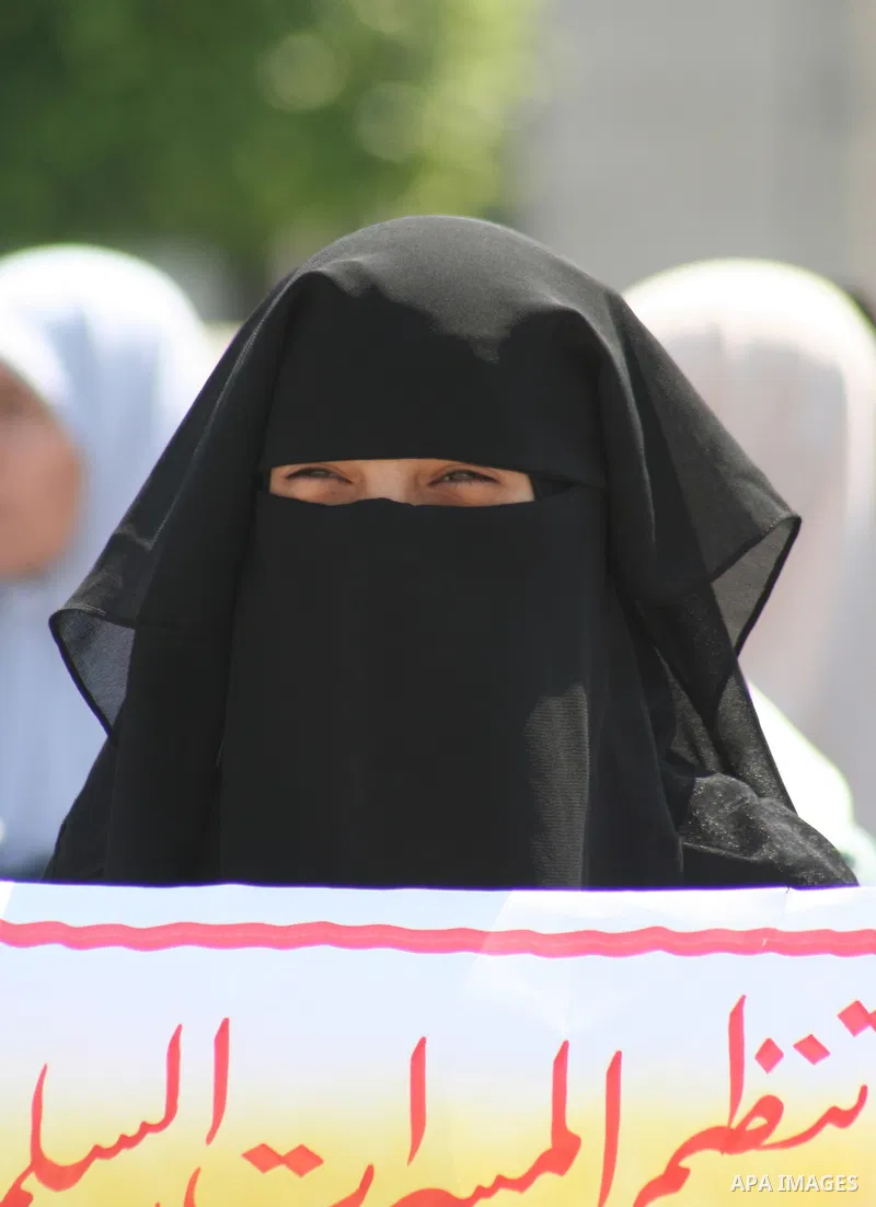 A Palestinian woman supporter of the Hamas movement holds a banner during a demonstration in front of the legislative council in Gaza City. Palestinian women demanding to halt the palestinian authority forces's violences...