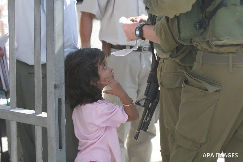 Palestinian child cross the Hawara checkpoint near the West Bank city of Nablus. The Israeli military announced an open-ended closure of the West Bank and Gaza Strip Wednesday, ahead of the weeklong Jewish holiday of Suk...