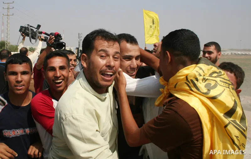Palestinian released from Israeli prison is warmly greeted by his relatives at the Erez checkpoint in the northern Gaza Strip, following his release at the Erez crossing by Israeli border police. Israel sent 29 Palestini...