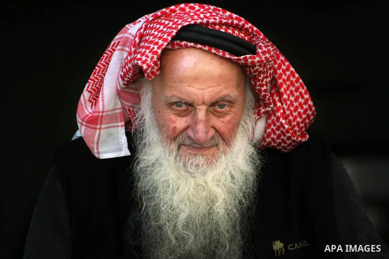 Palestinian elderly walk near a mosque, in Gaza City.