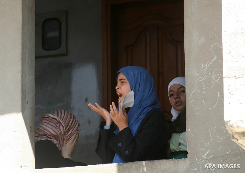 Palestinian relatives of militant Ahmed al-Helo of the Popular Resistance Committees group, who was killed in an Israeli air strike, mourn during his funeral in Gaza city. Israel killed four Palestinian militants in an a...