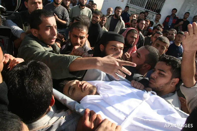 Palestinian relatives of militant Ahmed al-Helo of the Popular Resistance Committees group, who was killed in an Israeli air strike, mourn during his funeral in Gaza city. Israel killed four Palestinian militants in an a...