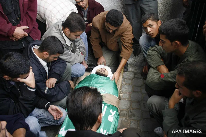 Palestinians carry the bodies of four Hamas militants during their funeral in Khan Younis refugee camp, southern Gaza Strip. The four Hamas militants were killed Wednesday as Israeli troops and Palestinian militants foug...