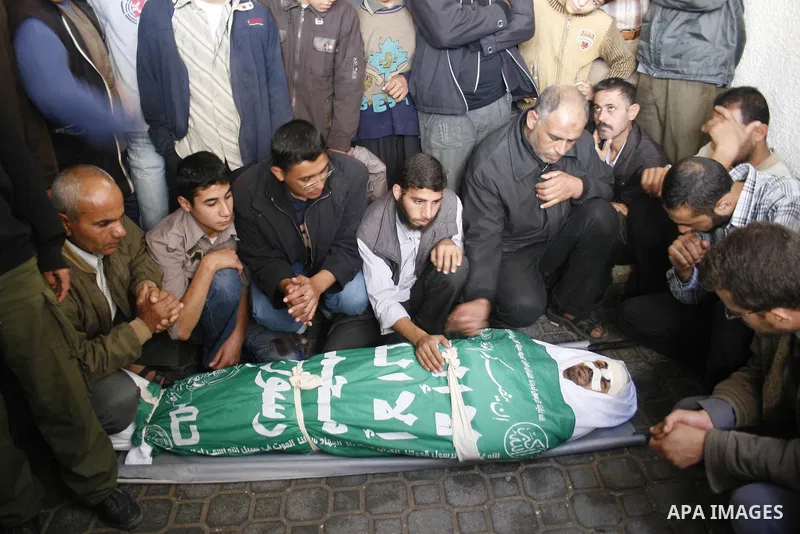 Palestinians carry the bodies of four Hamas militants during their funeral in Khan Younis refugee camp, southern Gaza Strip. The four Hamas militants were killed Wednesday as Israeli troops and Palestinian militants foug...
