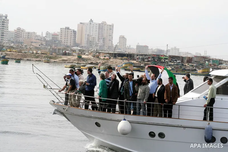 A group of pro-Palestinian activists and European politicians react as they arrive to Gaza City aboard a boat. The boat was allowed to dock in Gaza today despite a strict Israeli blockade, in the third such voyage in les...