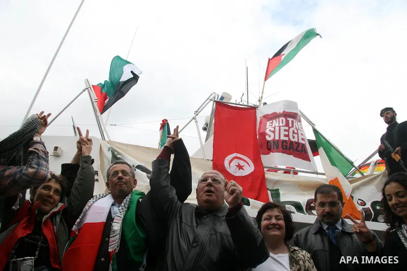 A crowd gathers around the "dignity" boat that departed from Cyprus yesterday afternoon to protest against the Israeli sanctions imposed on Gaza Strip since June 2007, at the port in Gaza City. The boat carrying 27 pro-P...