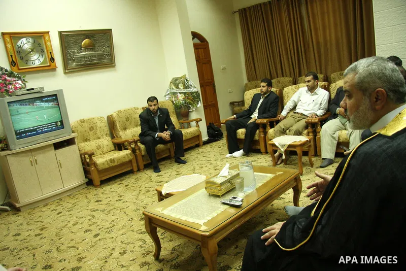 Palestinian Prime Minister Ismail Haniyeh watching the national football team play a friendly match against Jordan at his headquarters in Gaza city. The new stadium trembled as thousands of Palestinians cheered their nat...