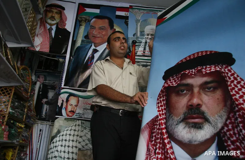 Palestinian vendor display posters of former Hamas Prime Minister Ismail Haneiya and Palestinian President Mahmoud Abbas at a shop in Gaza City. The implementation of an Egyptian plan for reconciliation between the Pales...