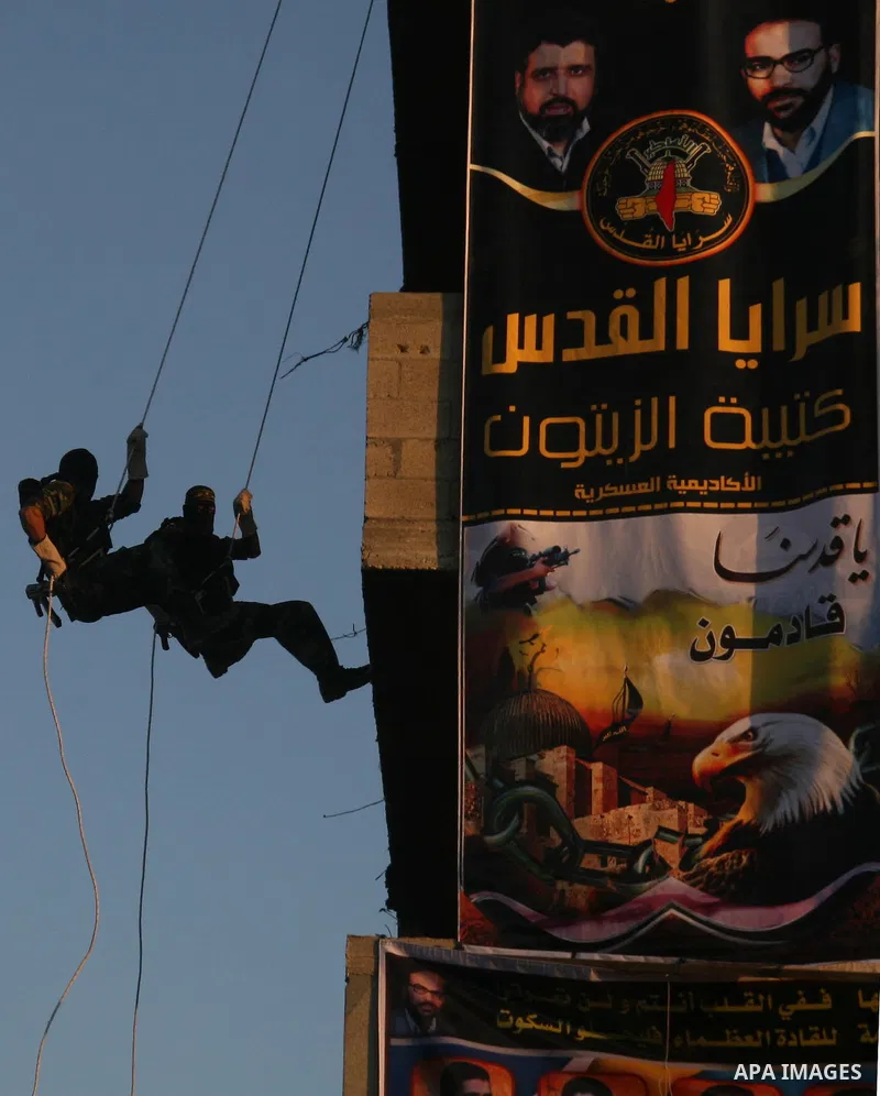 Masked Palestinian militants from Islamic Jihad take part in a training exercise as they demonstrate their skills for journalists on the outskirts of Gaza City. Tension surged in and around Gaza today as the Islamist rul...
