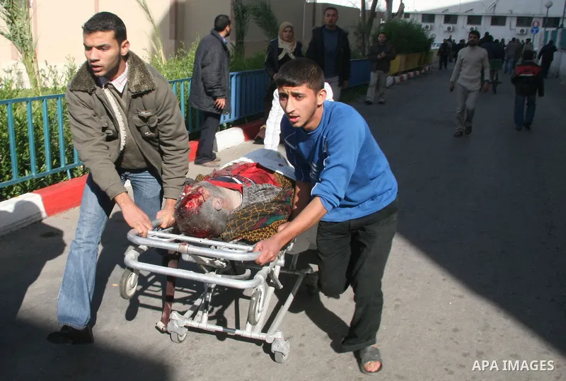 Palestinians wounded in Israeli missile strikes are seen in the emergency area at Shifa hospital in Gaza City, Saturday, Dec. 27, 2008. Israeli warplanes demolished dozens of Hamas security compounds across Gaza on Satur...