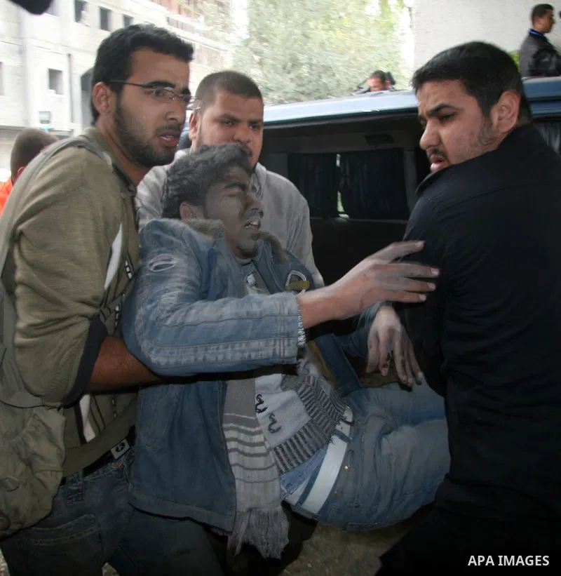 Palestinians wounded in Israeli missile strikes are seen in the emergency area at Shifa hospital in Gaza City, Saturday, Dec. 27, 2008. Israeli warplanes demolished dozens of Hamas security compounds across Gaza on Satur...