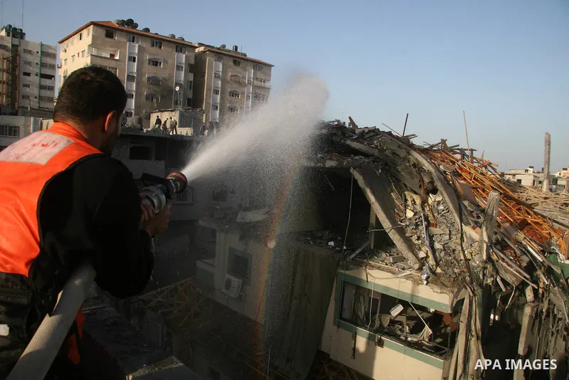 Palestinians look at destroyed buildings after an explosion from an Israeli missile strike in Gaza City. Israeli warplanes pounded the Hamas-ruled Gaza Strip for a third consecutive day on Monday and the Jewish state pre...