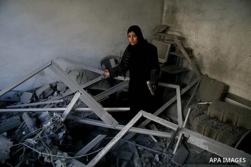 Palestinians look at destroyed buildings after an explosion from an Israeli missile strike in Gaza City. Israeli warplanes pounded the Hamas-ruled Gaza Strip for a third consecutive day on Monday and the Jewish state pre...
