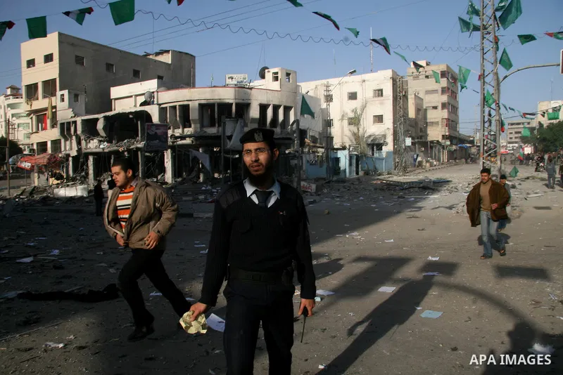 Palestinians look at destroyed buildings after an explosion from an Israeli missile strike in Gaza City. Israeli warplanes pounded the Hamas-ruled Gaza Strip for a third consecutive day on Monday and the Jewish state pre...