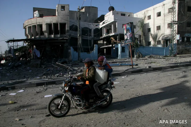 Palestinians look at destroyed buildings after an explosion from an Israeli missile strike in Gaza City. Israeli warplanes pounded the Hamas-ruled Gaza Strip for a third consecutive day on Monday and the Jewish state pre...