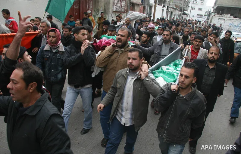 Palestinians mourns during the funeral of Dena Baloshathe and her four sisters in Jabalya refugee camp in the northern Gaza Strip December 29, 2008. Palestinian medics said five young sisters, one of them Dena Balosha, d...