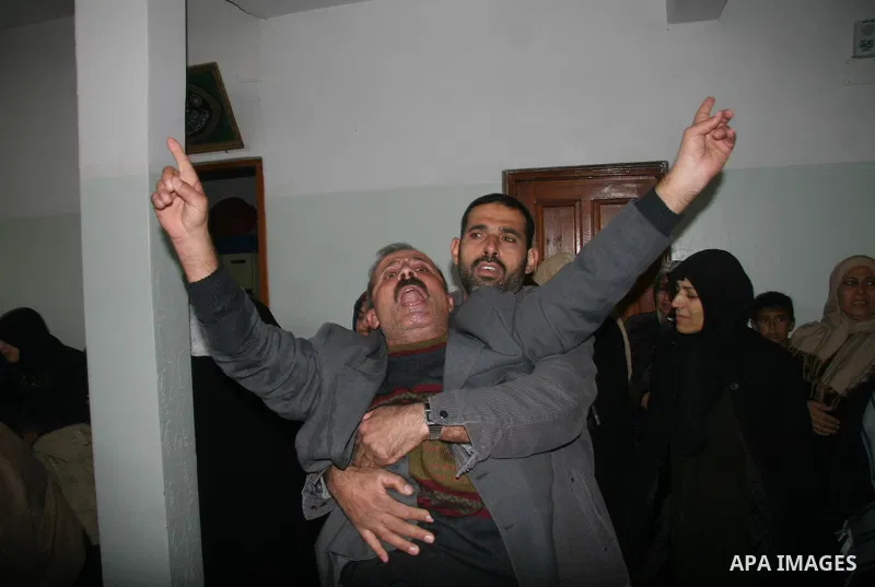 Palestinians mourns during the funeral of Dena Baloshathe and her four sisters in Jabalya refugee camp in the northern Gaza Strip December 29, 2008. Palestinian medics said five young sisters, one of them Dena Balosha, d...