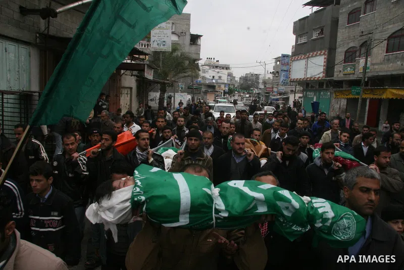 Palestinians mourns during the funeral of Dena Baloshathe and her four sisters in Jabalya refugee camp in the northern Gaza Strip December 29, 2008. Palestinian medics said five young sisters, one of them Dena Balosha, d...