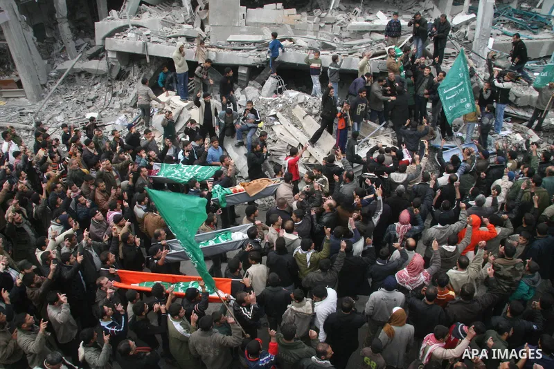 Palestinians mourns during the funeral of Dena Baloshathe and her four sisters in Jabalya refugee camp in the northern Gaza Strip December 29, 2008. Palestinian medics said five young sisters, one of them Dena Balosha, d...