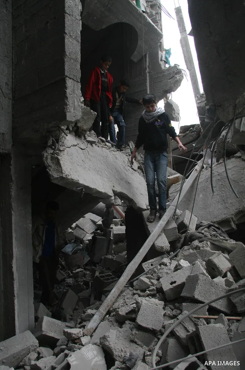 Palestinians look at destroyed buildings after an explosion from an Israeli missile strike in Gaza City. Israeli warplanes pounded the Hamas-ruled Gaza Strip for a third consecutive day on Monday and the Jewish state pre...